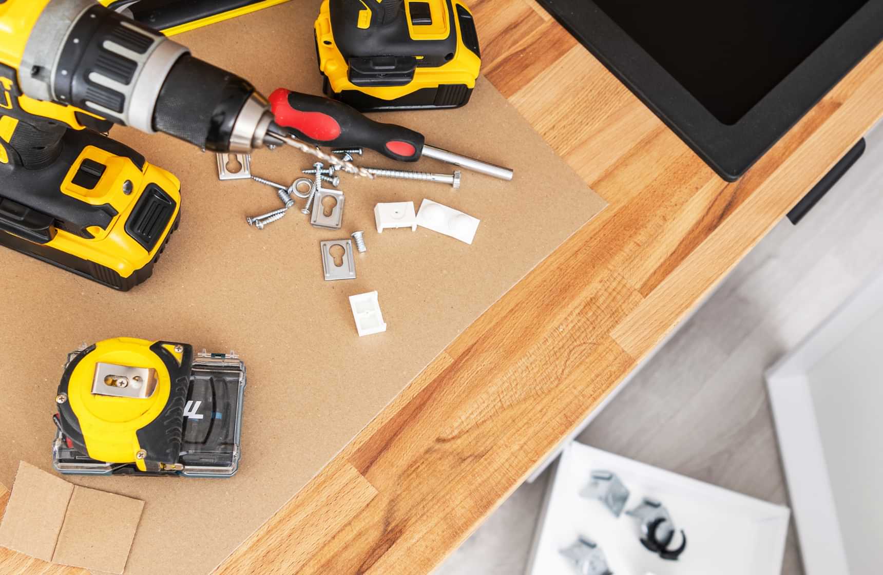 Power tools, screws and fittings laid out for home improvement repairs