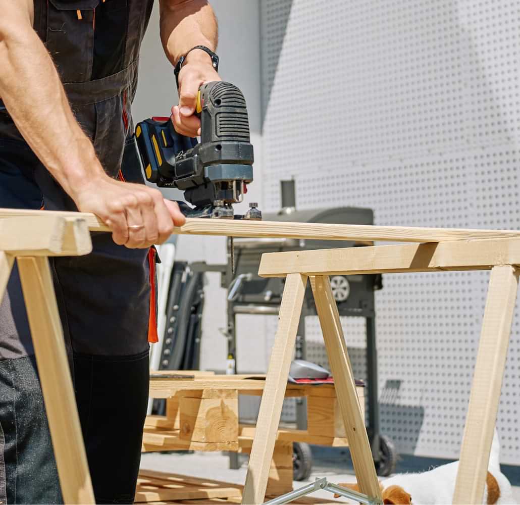 Carpenter cutting wood with a jigsaw