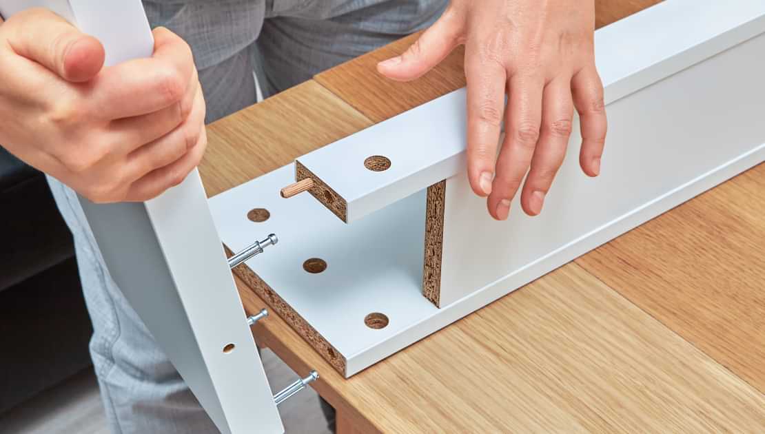 Assembling flat pack furniture panels with dowels and screws