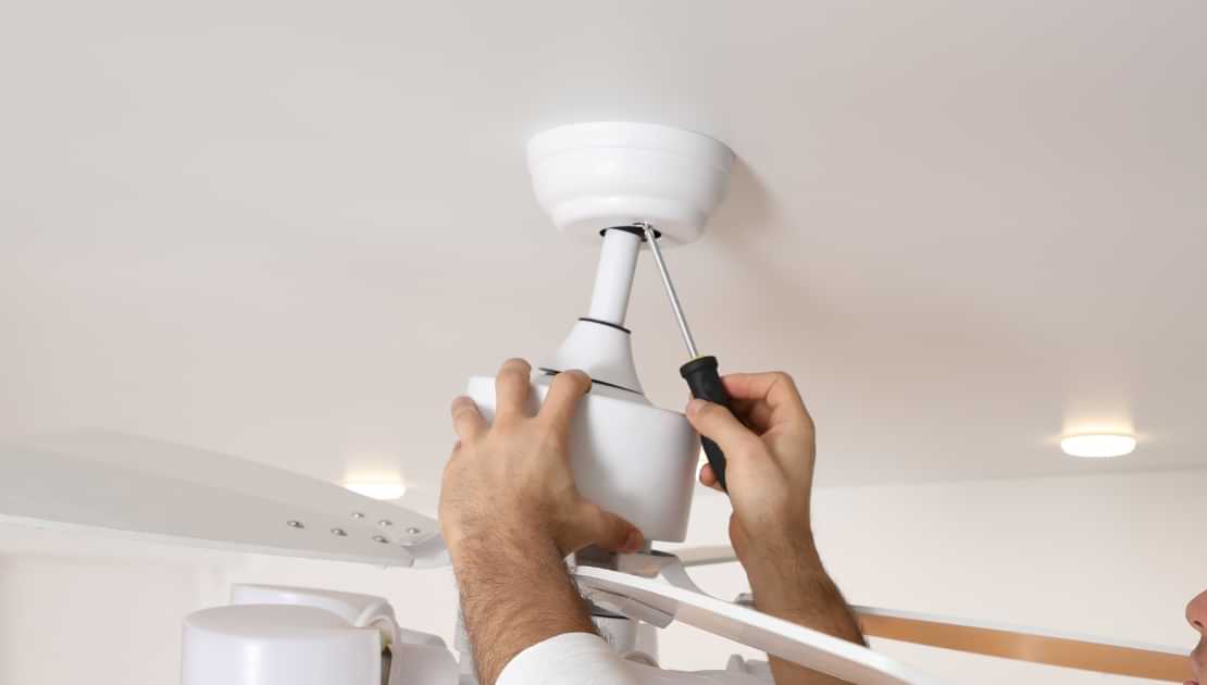 Installing a ceiling light fixture with a screwdriver