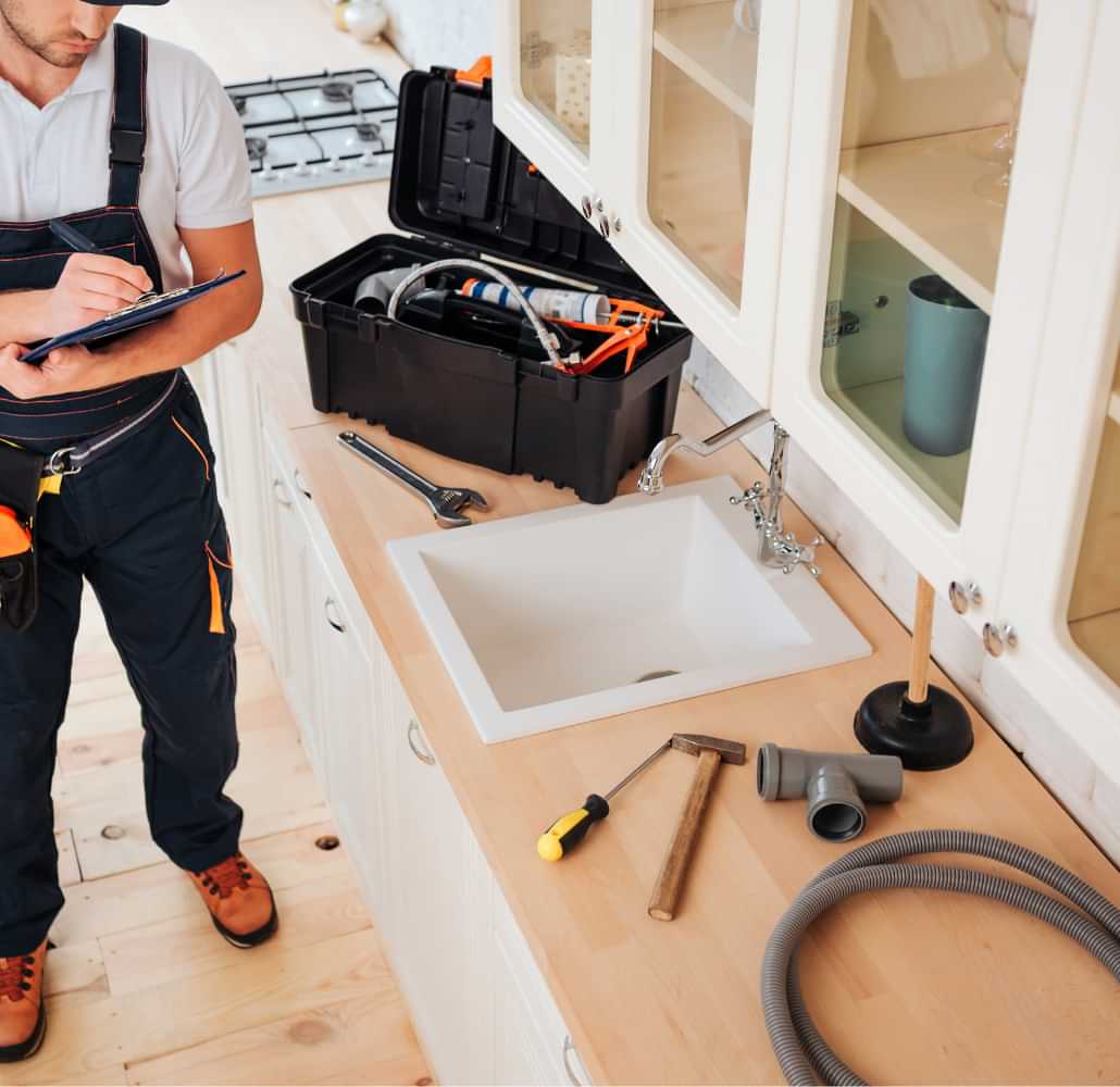 Property maintenance technician inspecting kitchen repairs