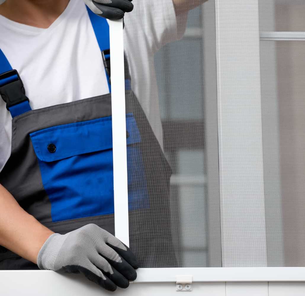 Technician installing a window screen